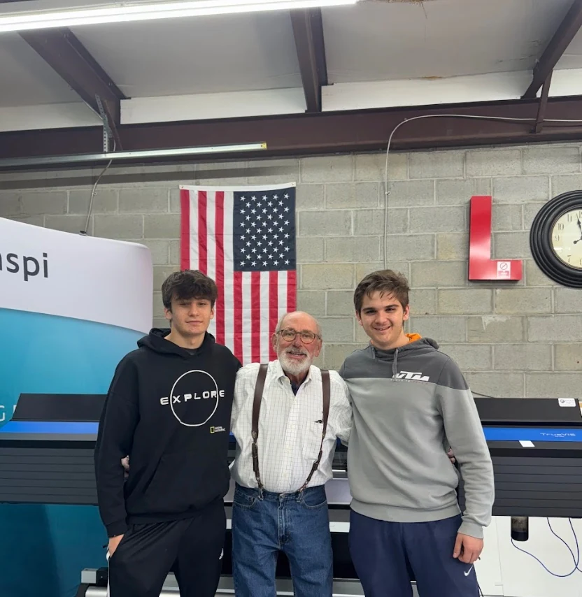 EMTA Signs founder Aydin Atas with team members Emir and Taha on the shop floor