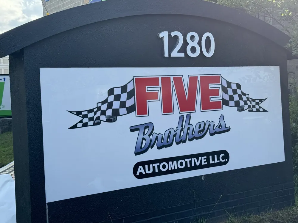 Monument sign with address numerals at a car dealership