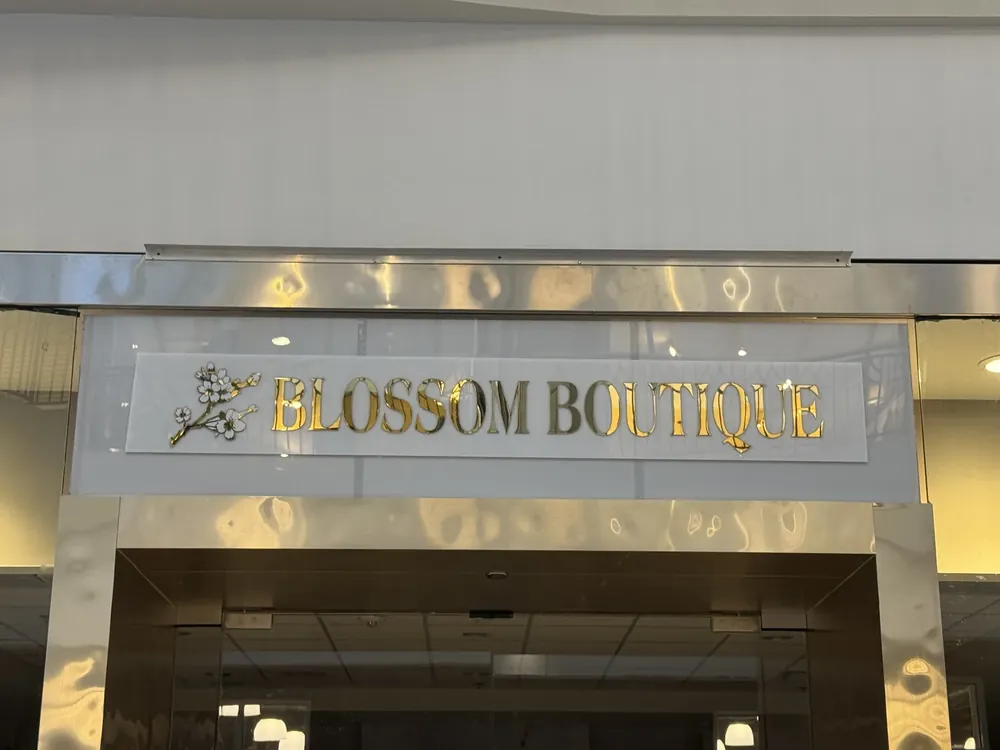 Gold dimensional letters above the Blossom Boutique entrance