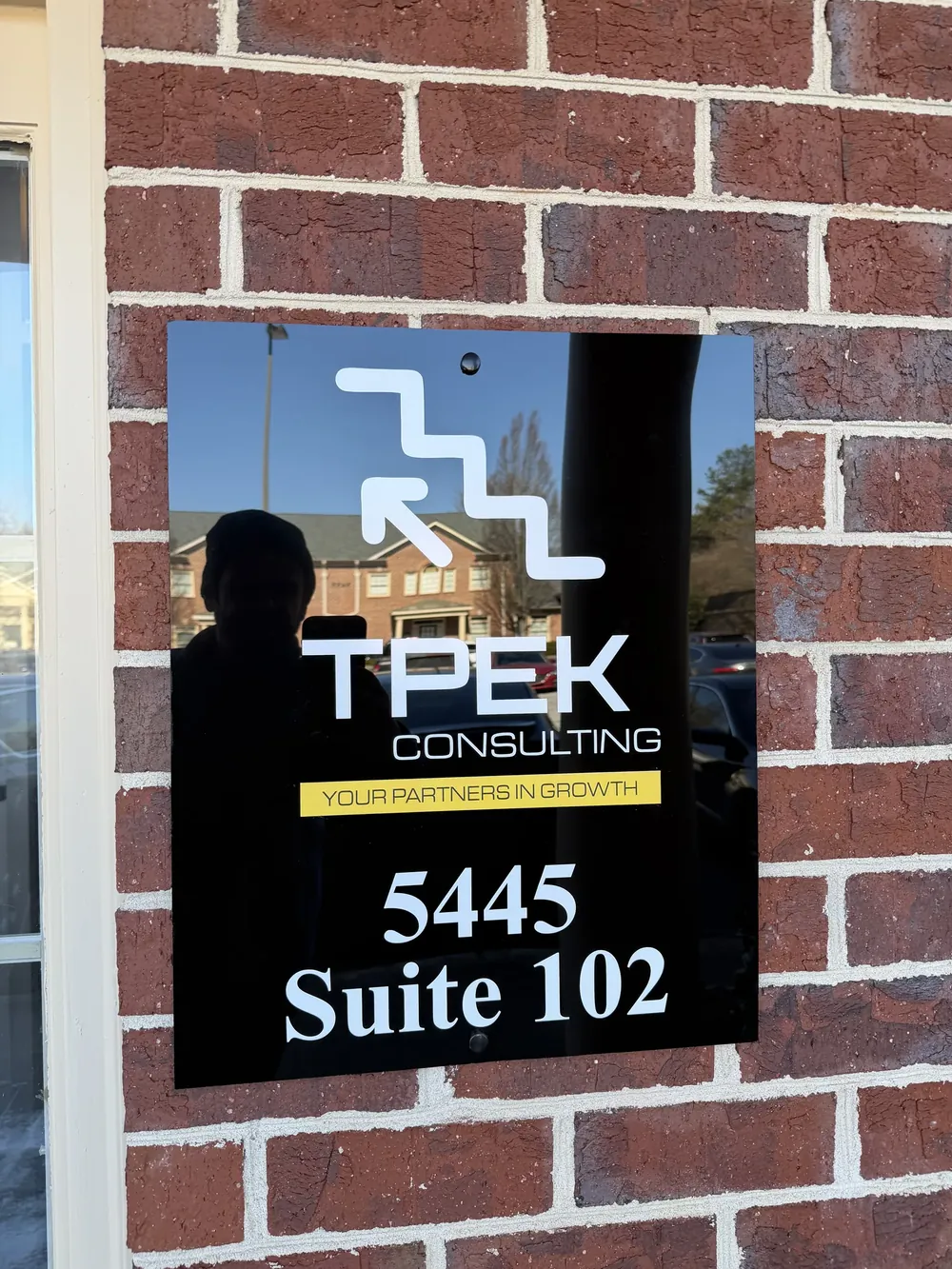 TPEK Consulting suite sign on brick