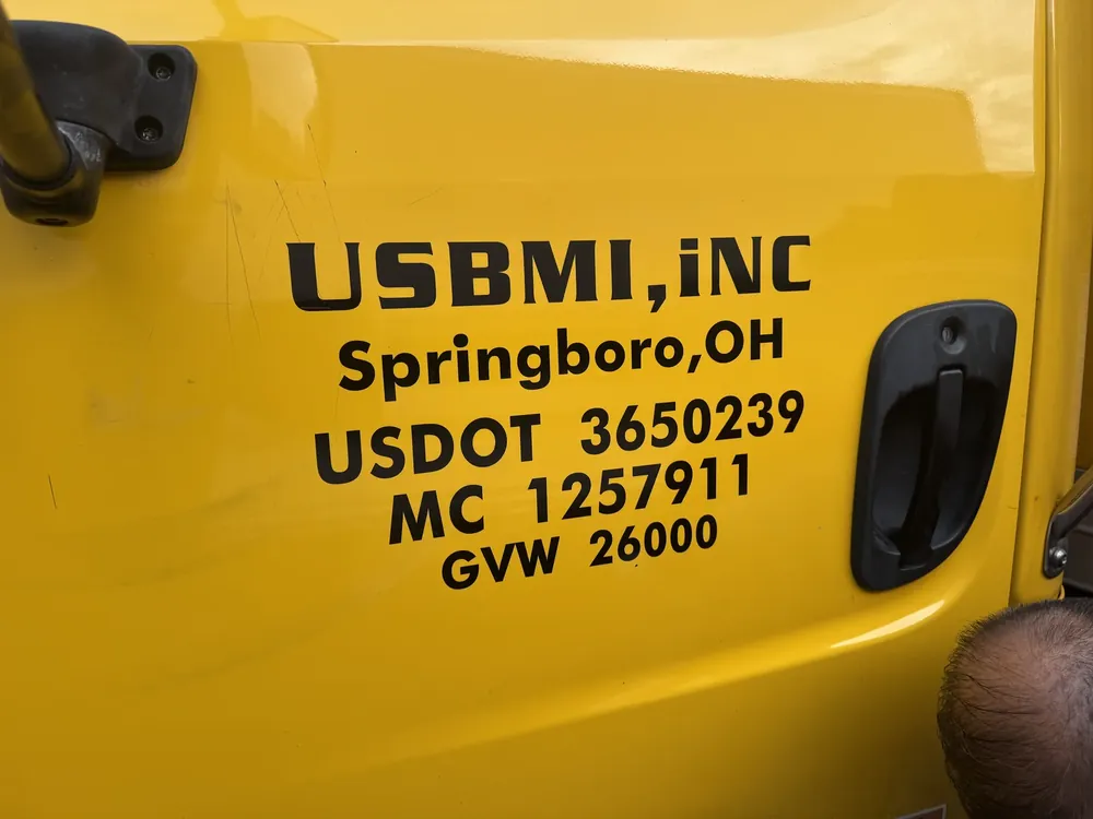DOT lettering on a yellow semi truck